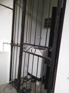 an iron bars in a room with a toilet at Homestay Townvilla Sibujaya Unit 6 in Sibu +2 photos