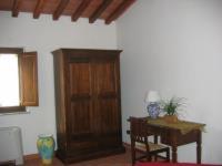 a living room with a table and a wooden door at Agriturismo Fiore in Viggianello