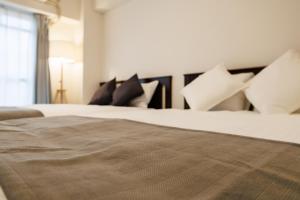 Ένα ή περισσότερα κρεβάτια σε δωμάτιο στο Shippo Town Hotel Nishiohashi-eki