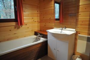 a bathroom with a tub and a sink and a bath tub at Gite De Boshut in Oignies-en-Thierache