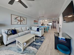 a living room with a couch and a table at The Enclave #705 in Orange Beach