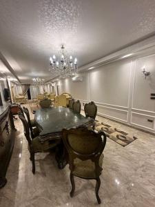 a dining room with a table and chairs and a chandelier at King Farouk Palace in Cairo