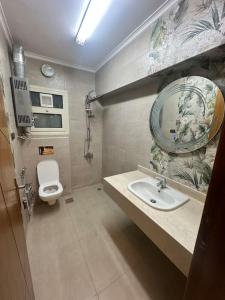 a bathroom with a sink and a toilet at King Farouk Palace in Cairo