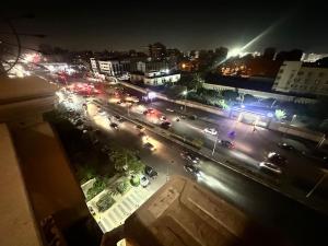 a view of a city street at night with traffic at King Farouk Palace in Cairo +9 photos