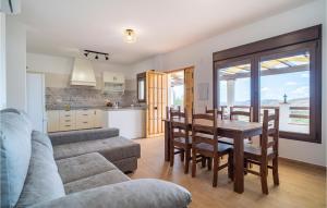 a living room with a couch and a table and a kitchen at Lovely Home In Periana in Periana