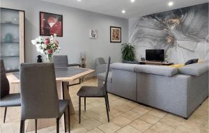 a living room with a couch and a dining room at 2 Bedroom Lovely Home In Herry in Herry