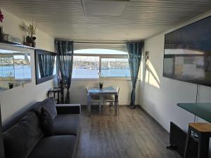 a living room with a couch and a table at 46 Île Paradise Vue Port avec clim in Cap d'Agde