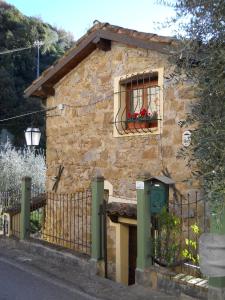 a stone house with a window and a fence at Lo Scoiattolo in Ventimiglia