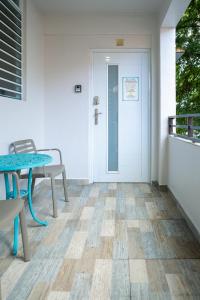 a porch with a table and chairs and a door at 103-Delightful GEM in the city, Close to the Beach with Free Parking in San Juan