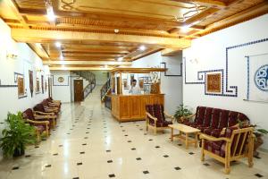 a waiting room with chairs and aorman at Malika Prime Hotel in Samarkand