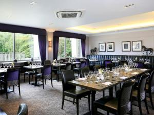 a dining room filled with tables and chairs at Macdonald Berystede Hotel & Spa in Ascot