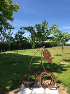 a metal sculpture of two o rings in a park at A Rural Retreat cabin with Private bathroom in Twyford