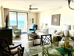 a living room with a couch and a table at Shoalwater 704 in Orange Beach