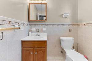 a bathroom with a toilet and a sink and a mirror at NYC & Downtown Newark Commuter Dream Stay in Newark +20 photos