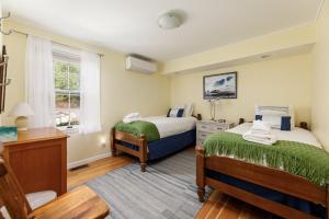 a bedroom with two beds and a window at Crystal Lake Serenity in Beulah