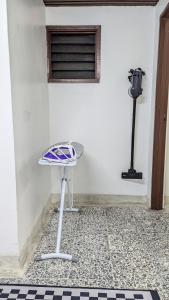 a table in front of a white wall with a window at Homestay Kemaman - Hitam Putih Homestay in Cukai +5 photos