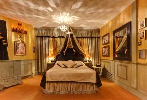 a bedroom with a bed and a chandelier at Hotel Pelirocco in Brighton & Hove