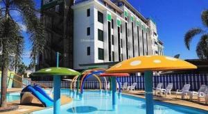 a swimming pool with a slide in front of a hotel at The One Hotel in Bung Kan +38 photos