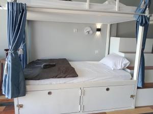 a white bunk bed with a pillow on it at Ankounamatata in Koh Rong Island