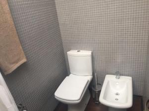 a bathroom with a white toilet and a bidet at Patio del Bastion 03 in Colonia del Sacramento