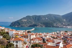 a view of a town and a body of water at Thea Home Hotel in Skopelos Town