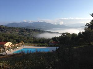 a swimming pool with a view of the mountains at Santa Pigna in Centola