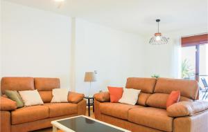 a living room with two couches and a table at Cozy Home In Cartagena With Kitchen in Cartagena