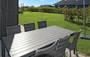 a wooden table and chairs on a patio at Holiday Home Flovt Havevej Vi in Flovt