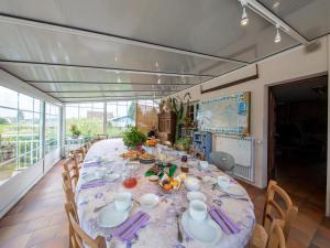 a dining room with a long table with chairs at Suite familiale confortable avec WiFi à Saint-Benoît-sur-Loire, animaux admis - FR-1-590-447 in Saint-Benoît-sur-Loire +6 photos
