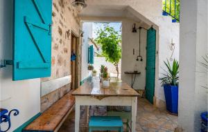 an alley with a wooden table and blue doors at Villa La Maison Adriatique in Zadar