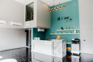 a room with a white counter and a blue wall at The Rizin Hotel Phratamnak in Pattaya South +43 photos