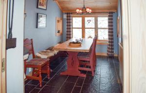 a dining room with a table and chairs and a window at Stunning Home In Rjukan With Wifi in Rjukan +17 photos