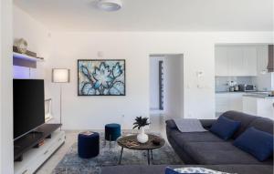 a living room with a couch and a tv at Villa Tina in Privlaka