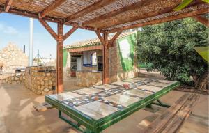 a patio with a table in front of a house at Gorgeous Home In Cartagena in Fuente-Álamo de Murcia +34 photos