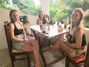 a group of women sitting at a table at Palm & Wild Hiriketiya in Dickwella