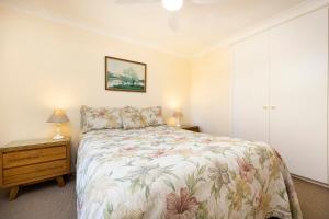 a bedroom with a bed and a dresser and a bed sidx sidx sidx sidx at Beachpoint, 401 in Forster