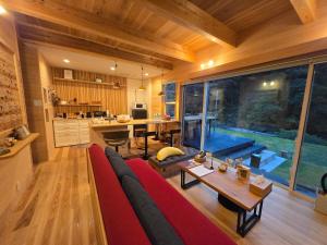 a living room with a large couch and a table at Rexline中辺路 in Tanabe
