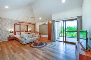 a living room with a couch and a table at Melhor Stays Villa - L-M102 Luxurious 4BHK villa with private pool, Anjuna in Anjuna +40 photos