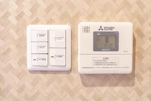 a white electronic device sitting on top of a table at Yiyihouse shinsaibashi in Osaka