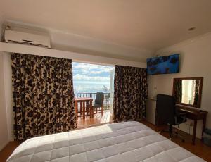 a bedroom with a bed and a window with a view at Little Italy Hotel in Nuku‘alofa +40 photos