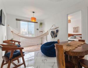 a living room with a hammock and a table and chairs at Casa Caracol in Tulum
