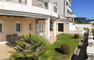 a courtyard of a building with a table and chairs at Two-Bedroom Apartment In Komarna in Klek