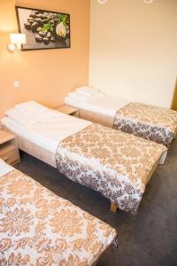 Postel nebo postele na pokoji v ubytování Ankur Hotell