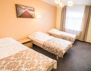 Postel nebo postele na pokoji v ubytování Ankur Hotell