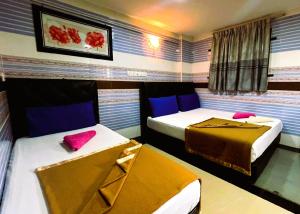 Postel nebo postele na pokoji v ubytování ARK Hotel New Wave Shah Alam