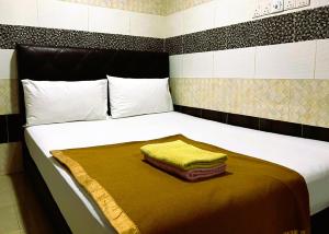 Postel nebo postele na pokoji v ubytování ARK Hotel New Wave Shah Alam