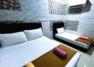 Postel nebo postele na pokoji v ubytování ARK Hotel New Wave Shah Alam