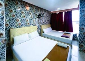 Postel nebo postele na pokoji v ubytování ARK Hotel New Wave Shah Alam