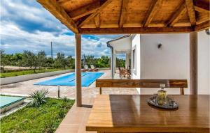 a patio with a wooden table and a swimming pool at Cozy Home In Debeljak With Wifi in Debeljak +17 photos