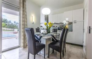 a dining room with a table and chairs and a kitchen at Cozy Home In Debeljak With Wifi in Debeljak